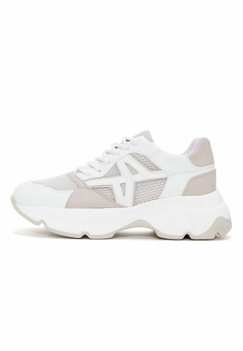 Sneakers featuring a white and light beige design, mesh and synthetic materials, rounded shape, thick white sole with a wavy edge.