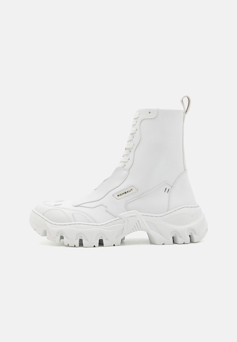 White ankle boots with a chunky sole, smooth leather upper, prominent lacing, and a back loop for easy wear. Features textured accents.