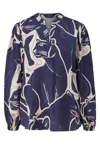 Blouse bleu marine à manches longues, coupe ample, avec des motifs abstraits blancs en contour de grands visages et corps de chats.