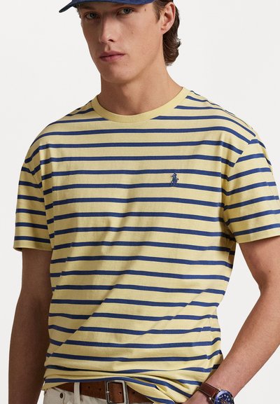 Κίτρινη μπλούζα με ρίγες σε ναυτικό μπλε, από βαμβακερό υλικό, με ribbed λαιμόκοψη, που διαθέτει ένα μικρό κεντημένο λογότυπο στο στήθος.