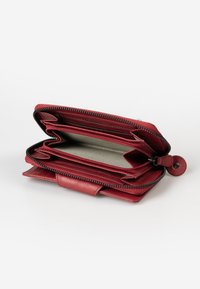 Red leather wallet with a zip closure, featuring multiple card slots and compartments, textured interior, and black zipper accents.