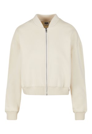 Svetlá krémová bomber bunda so zipsom, ribbenými manžetami a lemom. Vyrobená z mäkkého materiálu s okrúhlym golierom a voľným strihom.