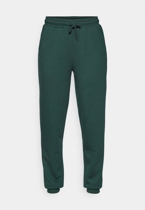 Green sweatpants made of soft, textured fabric. Features elastic waistband with drawstring, tapered legs, and fitted cuffs at the ankles.