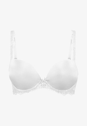 Valkoinen pehmustettu rintaliivi pitsireunuksella, jossa on säädettävät hihnat, pieni koristeellinen nauha keskellä ja sileä kangaspinta.