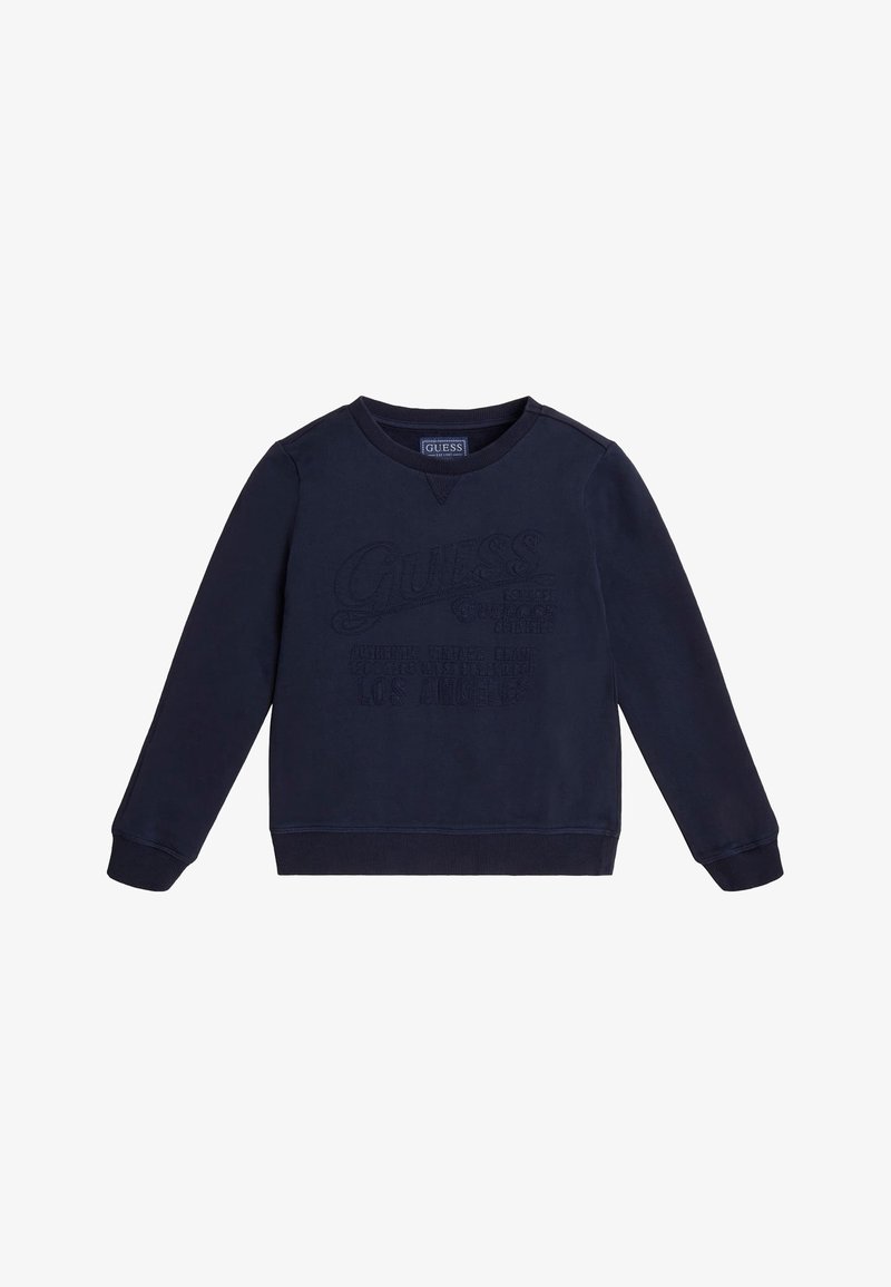Sweat-shirt en coton bleu marine à manches longues, col rond, avec logo "Guess" embossé sur le devant. Poignets et ourlet côtelés.