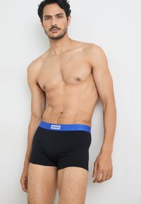 Black boxer briefs with a blue waistband labeled "HUGO." Features a fitted design and soft, stretchy material.