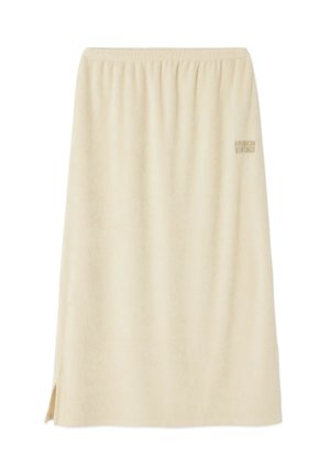 Béžová bavlněná sukně s elastickým pasem, rovný střih, boční rozparky a jemný detail s logem. Měkká textura a lehký design.