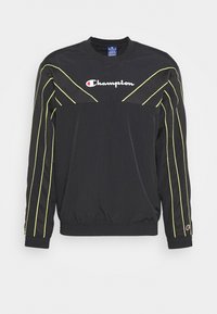 Czarny sportowy sweatshirt z długimi rękawami, akcentami z siateczki i jasnymi żółtymi paskami. Posiada okrągły dekolt i haftowane logo.