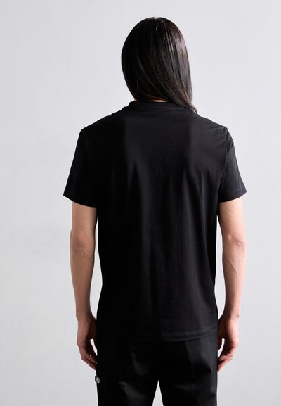 Black cotton T-shirt with a crew neck and short sleeves, showing a smooth texture. The back view displays plain design without embellishments.