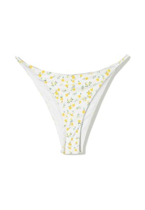 Bas de bikini blanc avec un motif floral composé de petites fleurs jaunes et de feuilles vertes. Fines bretelles avec un design en V. Tissu doux.