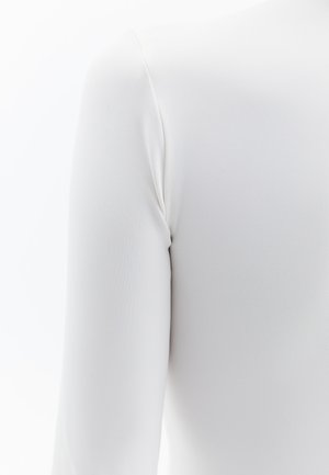 Garment lungo bianco a maniche lunghe realizzato in tessuto liscio e elasticizzato. Presenta una silhouette aderente e una cucitura sottile sulla spalla.