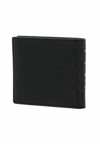 Portefeuille noir bi-fold avec un motif en relief "HUGO" sur le devant, finition en cuir lisse et surpiqûres contrastées sur les bords.