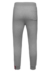Graue Sweatpants aus weichem Stoff mit einer schmal zulaufenden Passform, elastischem Bund und einer einzelnen Gesäßtasche. Mit gerippten Bündchen.