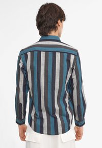Striped shirt featuring alternating teal, gray, and navy vertical stripes, long sleeves, and buttoned cuffs with a classic collar design.
