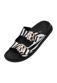 Sandali a strisce zebrate in bianco e nero con due cinturini regolabili, fibbie dorate e suola nera texturizzata.