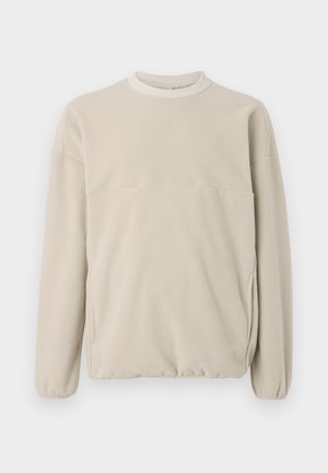 Light beige fleece sweatshirt with a crew neck, elastic cuffs, and a front pocket. Soft texture, relaxed fit, and minimalistic design.