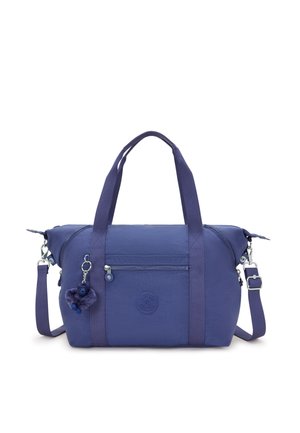 Purple fabric handbag with dual handles and a removable shoulder strap. Features a front zip pocket and a furry keychain accessory.