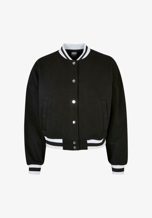 Veste bomber noire avec col et poignets à rayures blanches, fermeture à boutons-pressions, deux poches latérales et coupe courte. Tissu à texture douce.