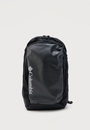 Black Columbia backpack with a large front zippered compartment and white vertical brand logo on a plain white background.