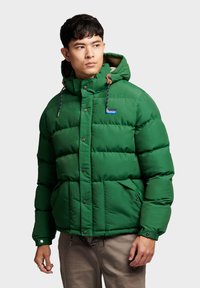Green insulated puffer jacket with a hood, featuring a zip and snap button closure, front pockets, and contrast drawstrings.