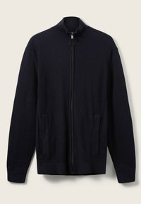 Marineblauer Reißverschluss-Pullover aus ribbeligem Strickstoff, mit hohem Kragen und zwei Seitentaschen. Weicher Stoff mit geraden Ärmeln.
