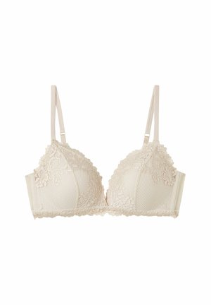 Beige lace bra with a textured base, soft cups, and adjustable straps. Features intricate lace edges and a smooth finish.
