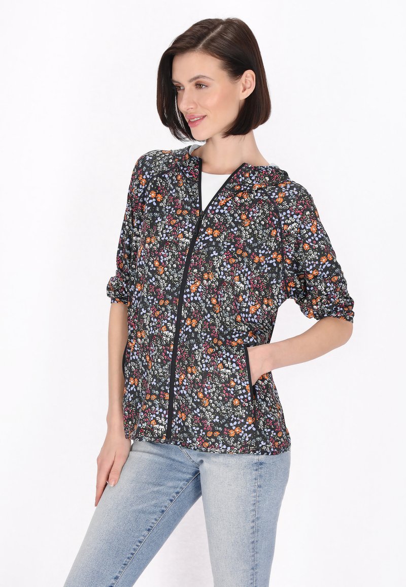 Jachetă cu fermoar, cu imprimeu floral, de culoare neagră, cu modele de flori multicolore, din material ușor, cu mâneci scurte și buzunare laterale.