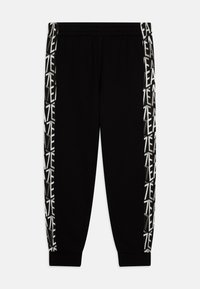 Zwarte sweatpants met een elastische tailleband, voorzien van contrasterende geprinte zijstrepen in het wit en beige met abstracte tekst.