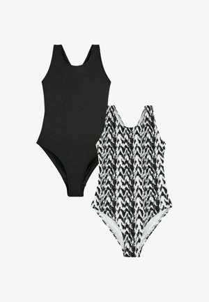 Deux maillots de bain une pièce sans manches, l'un uni noir et l'autre avec un motif abstrait en zigzag noir et blanc, présentés sur un fond blanc.