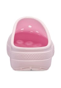 Pink slip-on clog with a smooth exterior, textured sole, and rounded toe. Interior features a contrasting glossy pink finish.