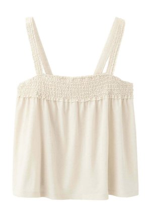 Haut sans manches de couleur crème avec partie supérieure smockée élastique et larges bretelles, ample sous la bande smockée.