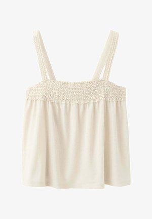 Haut sans manches de couleur crème avec partie supérieure smockée élastique et larges bretelles, ample sous la bande smockée.