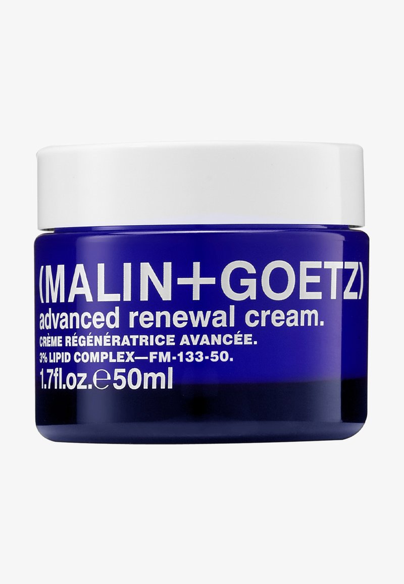 Blue glass jar with a white lid. Label features bold white text detailing product name, volume, and formulation ingredients.