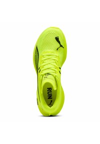Zapatilla de correr de color amarillo brillante con parte superior de malla, acentos negros y cordones. Incluye el logo en el lateral y "RUN" impreso en el interior.