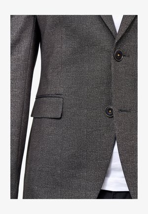 Grau gemusterter Blazer aus strukturiertem Stoff. Verfügt über zwei Knöpfe, eine einzelne Brusttasche und Reverskragen. Weißes Hemd darunter sichtbar.