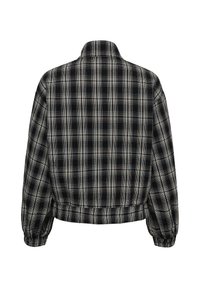 Veste à manches longues à carreaux noirs et blancs avec poignets et taille élastiques, vue de dos.