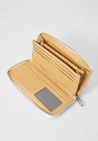 Yellow leather wallet with a zip closure, multiple card slots, a zipped pocket, and a clear ID window. Smooth texture and minimal design.