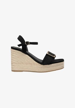 Sandale compensée en suède noir avec une plateforme en corde de jute, dotée d'une bride de cheville réglable et d'un accent en métal doré.