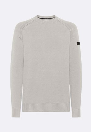 Maglione grigio chiaro a maniche lunghe in maglia con collo rotondo, polsini e orlo a costine, e una piccola toppa nera sulla parte superiore della manica sinistra.