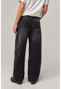 Black wide-leg jeans with a faded finish, featuring dual back pockets and a classic waistband. The fabric has a slight texture.