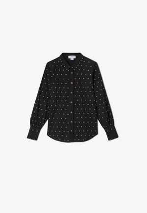 Zwarte blouse met lange mouwen, goudkleurige polkadots, puntige kraag en knoopmanchetten.