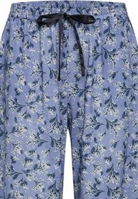 Light blue pants with an elastic waistband and black tie, featuring a floral pattern of white blooms and green leaves throughout.