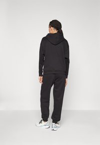 Puma LOUNGEWEAR TRACKSUIT SET - Tracksuit - black