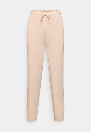 Beige, smalle joggers med snøre i taljen, sidelommer og et blødt, struktureret stof. Har logo-broderi på benet.