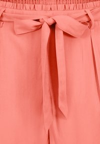 Peach-colored trousers with a soft, lightweight fabric. Features an elastic waistband and a tie belt for adjustable fit.