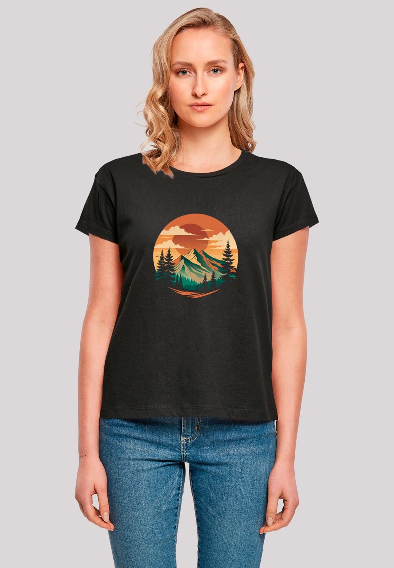 Black short-sleeve t-shirt featuring a circular graphic of mountains and trees in orange, green, and beige tones, with a relaxed fit.