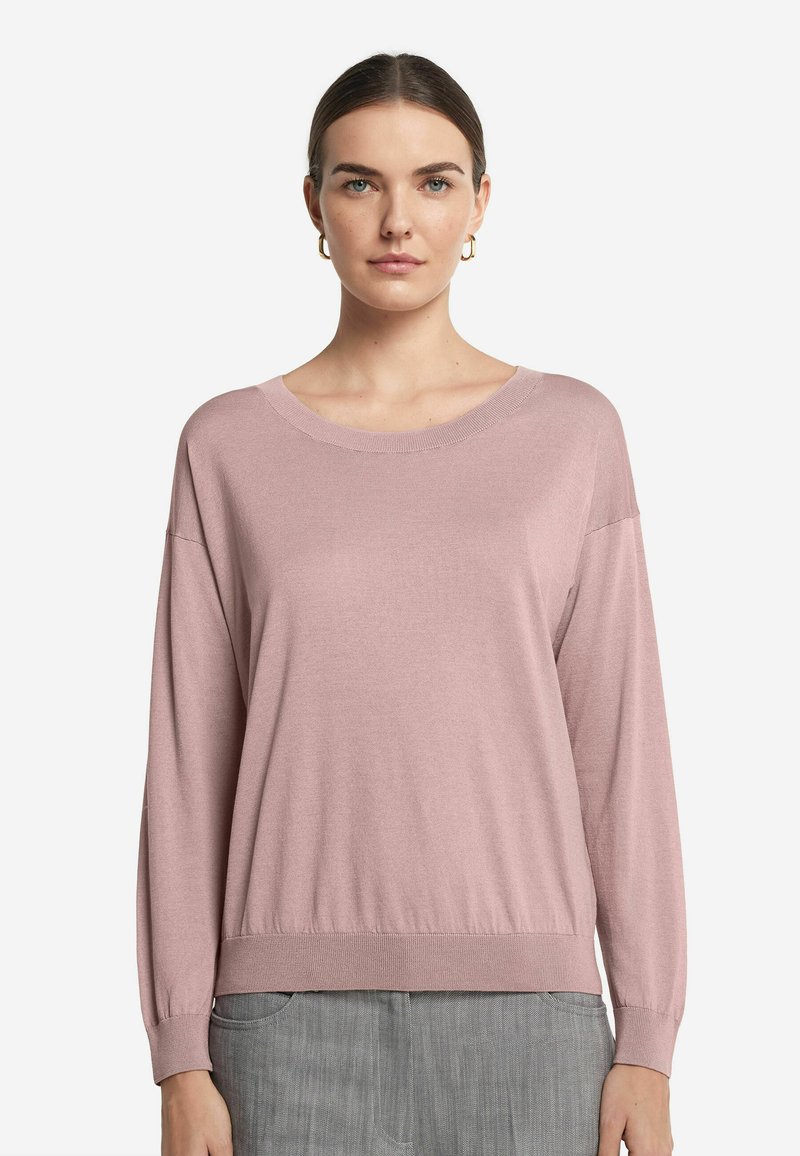 Pull en tricot rose clair avec un col rond et des manches longues. Présente un ourlet côtelé et une texture douce, complété par une coupe décontractée.