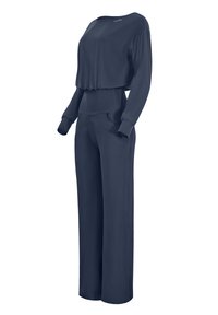 Navy blue lounge set featuring a loose long-sleeve top with a wide neckline and tapered pants with pockets, made from smooth fabric.