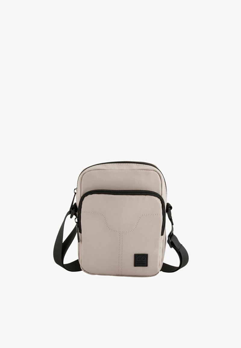 Beige crossbody bag made of textured fabric, featuring a zip closure, adjustable strap, and a front zippered pocket with logo detail.