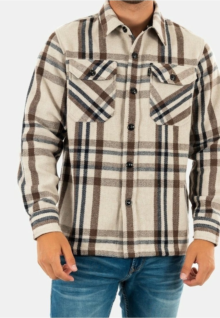 Rutig flanellskjorta i beige, brun och blå. Har två bröstfickor med lock, knappstängning och krage. Mjuk textur.